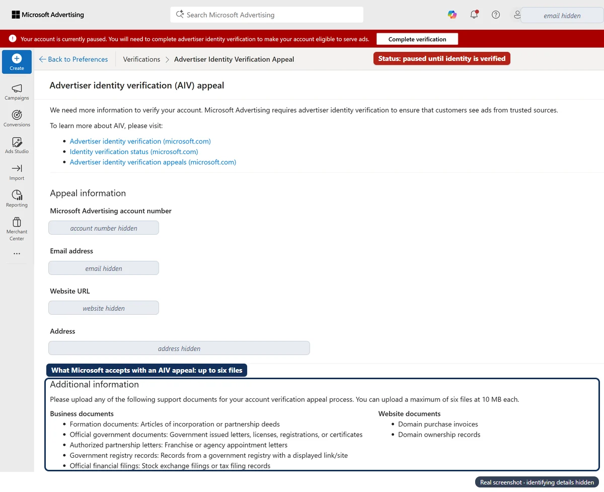 Microsoft Advertising account with a red banner: ‘Your account is currently paused. You will need to complete advertiser identity verification to make your account eligible to serve ads.’ and a ‘Complete verification’ button. Below it, the ‘Advertiser identity verification (AIV) appeal’ form, with the account number, email, website and address hidden. A navy box marks the ‘Additional information’ section: upload up to six files at 10 MB each, from business documents (formation documents, official government documents, authorised partnership letters, government registry records, official financial filings) and website documents (domain purchase invoices, domain ownership records).